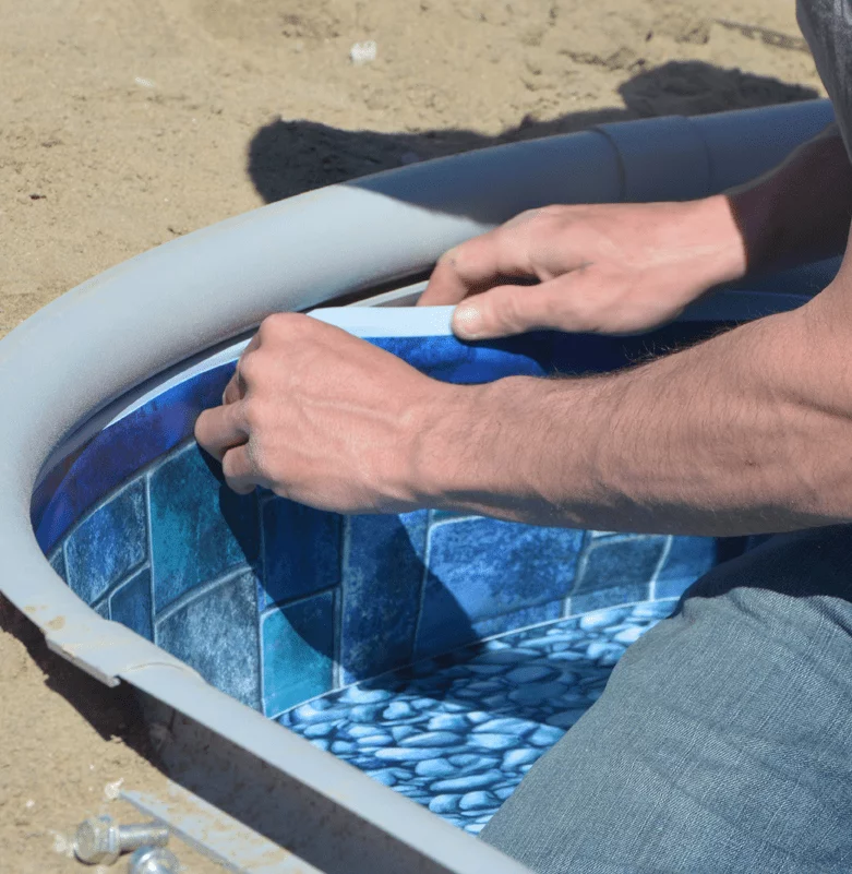 man fixing interior of hot tub