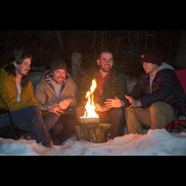 4 people around fire